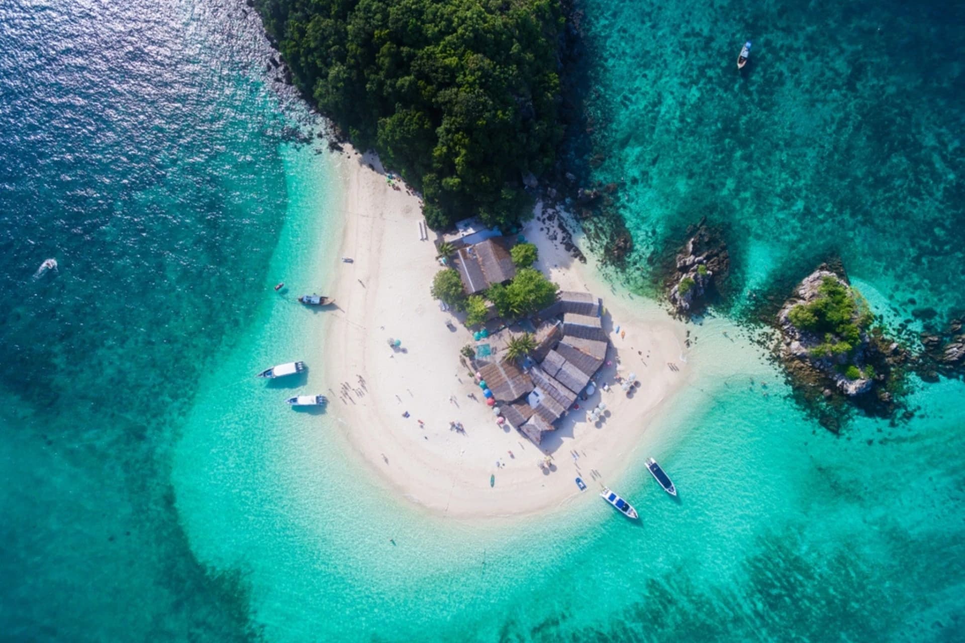 Aerial view of a tropical sandbar island surrounded by turquoise sea