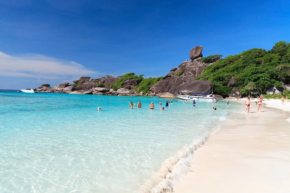 White sandy beach with turquoise water and Sailing Rock on Similan Island